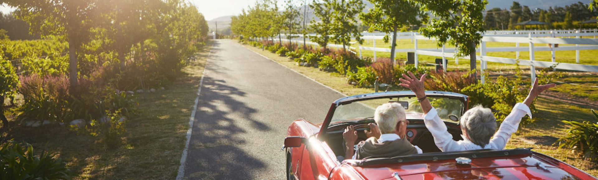 Seniors enjoying retirement driving down a highway